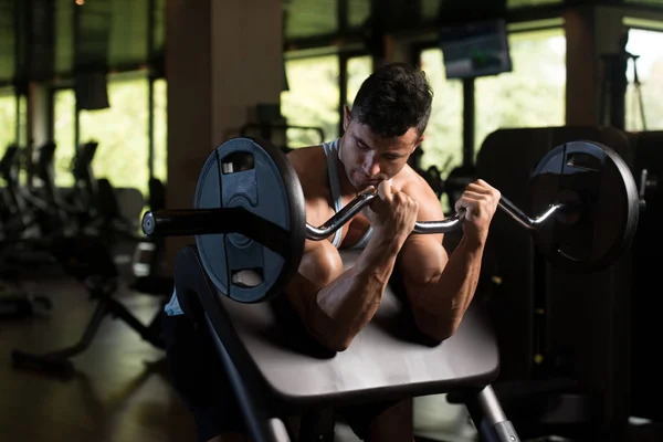 Biceps Exercise With Barbell in a Gym — Stock Photo, Image