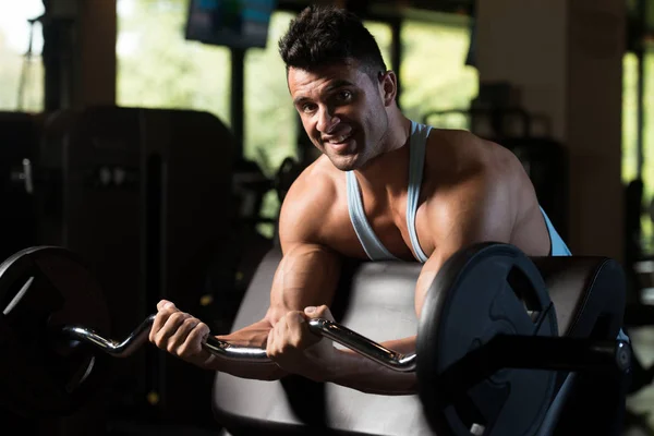 Biceps Exercise With Barbell in a Gym — Stock Photo, Image