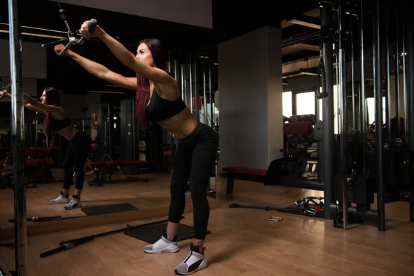 Beautiful Woman Exercising Back On Machine — Stock Photo, Image