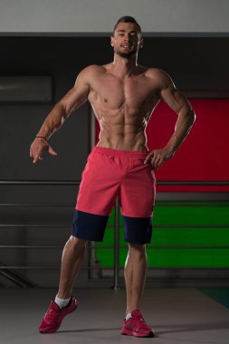 Yakışıklı kaslı adam içinde jimnastik salonu kas esneme