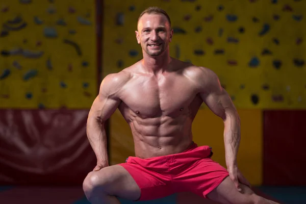 Muskulöser Bodybuilder zeigt seinen vorderen Bauch — Stockfoto