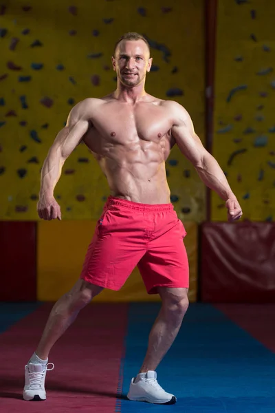 Muscular culturista mostrando su frente abdominal abdominales — Foto de Stock