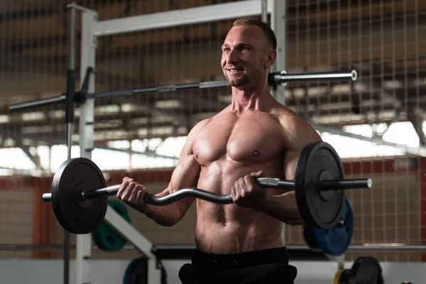 Muscular Man Exercising Biceps With Barbell — Stock Photo, Image