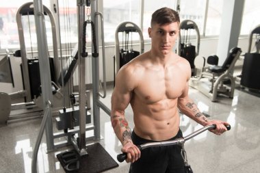 Pazı için ağır egzersiz yaparak vücut geliştirmeci