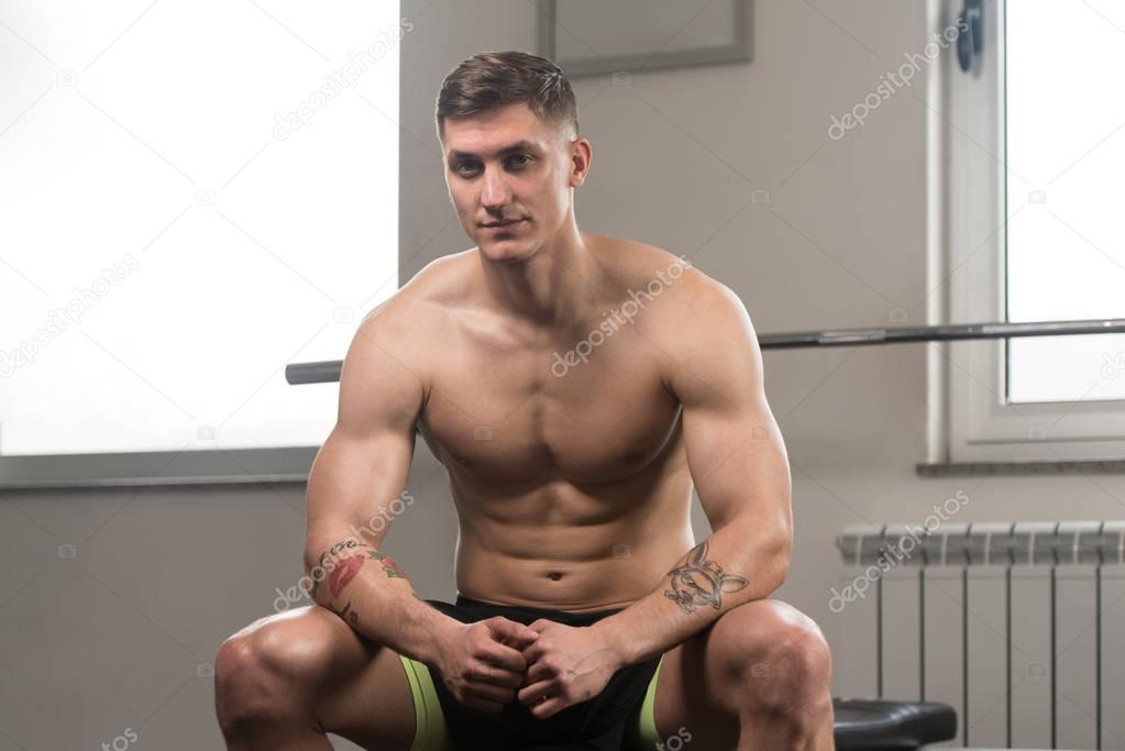 Muscular Man Resting On Bench After Exercise
