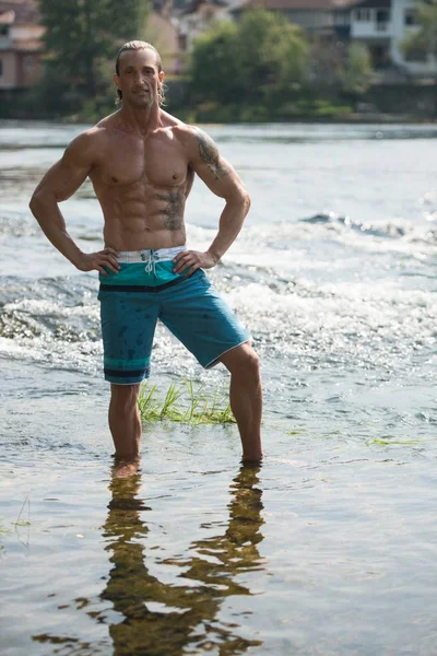 Bodybuilder lässt Muskeln im Freien in der Natur spielen — Stockfoto