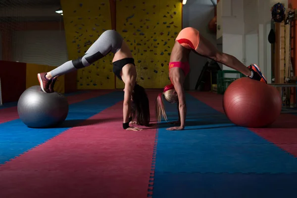 Femme en bonne santé couple étire sur la balle — Photo