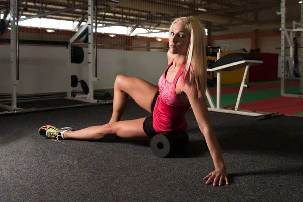 Young Sporty Fit Woman Stretches With Roller — Stock Photo, Image