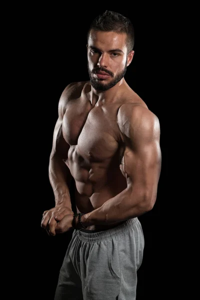 Muscular Model Flexing Muscles On Black Background — Stock Photo, Image