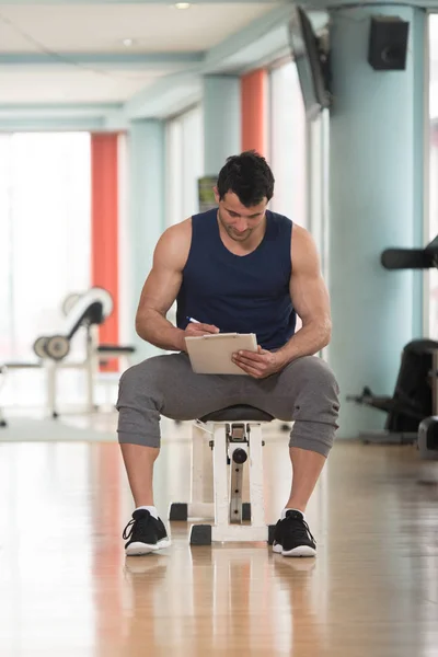 Handsome Personal Trainer With A Clipboard — Stock fotografie