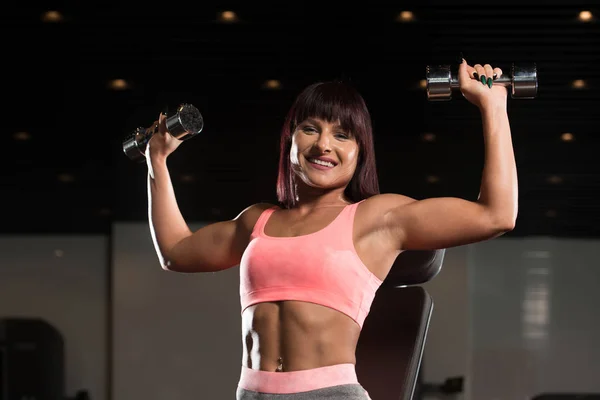 Woman Exercising Shoulders With Dumbbells In The Gym And Flexing — Stock Photo, Image