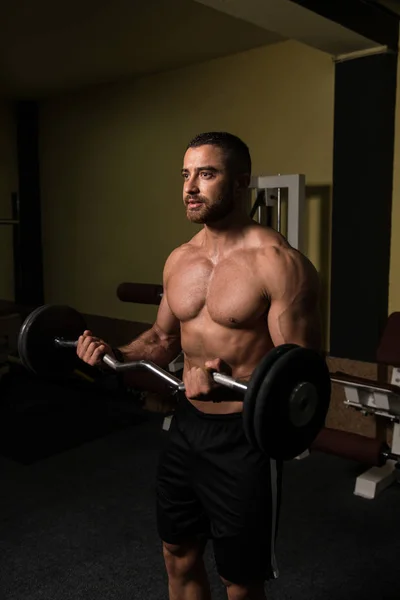 Man In The Gym Exercising Biceps With Barbell — Stock Photo, Image