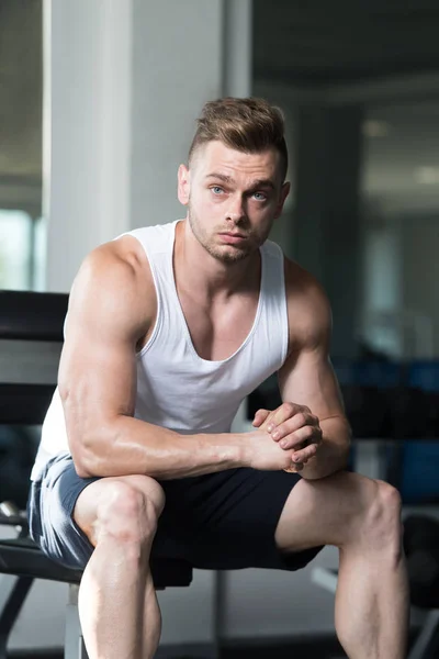 Masculino descansando no banco no centro de fitness — Fotografia de Stock