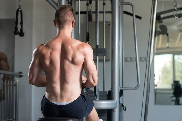 Homem muscular exercitando nas costas — Fotografia de Stock