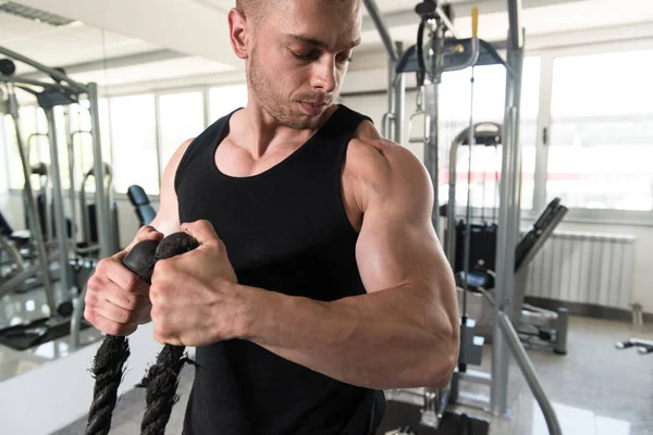 Giovane uomo che esercita Bicipiti in palestra — Foto Stock