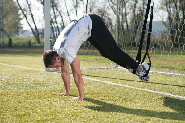 Young Man Exercising Trx Straps in Park — Stock Photo, Image