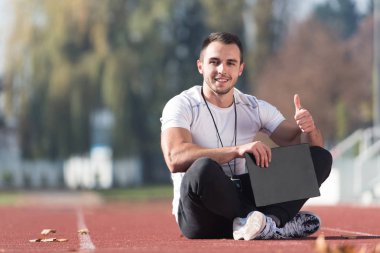 Kişisel antrenör başparmak-up işaret gösteren