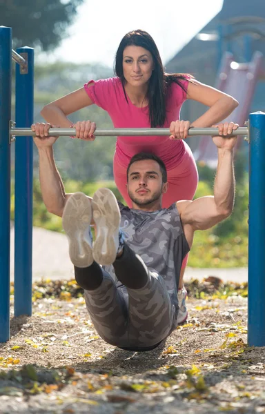 Couple faisant de l'exercice avec trempettes Bar dans le parc — Photo