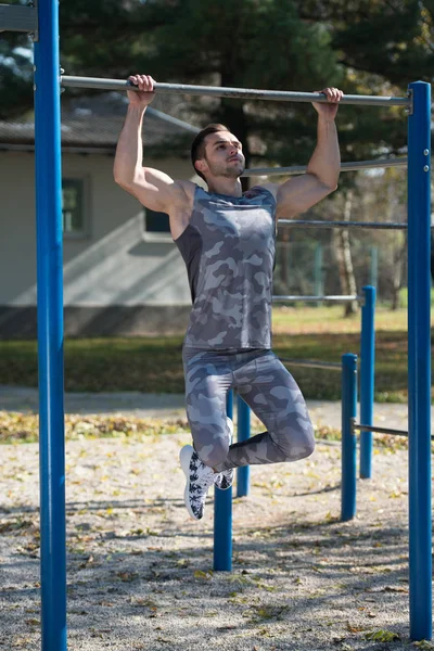 Athlete Doing Exercise With Dips Bar in Park — Stock Photo, Image