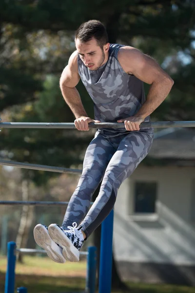 Attractive Man Training With Dips Bar — Stock Photo, Image