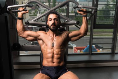 Kaslı adam arka için ağır egzersiz yaparak