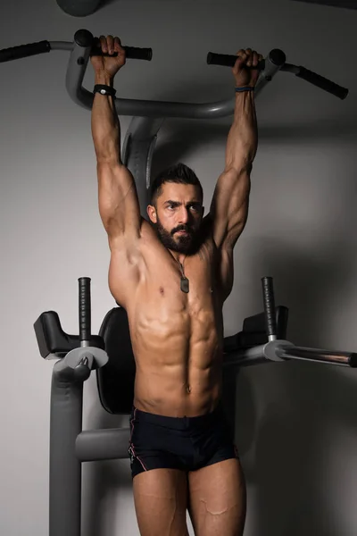 Uomo che fa Pull-up Bar Esercizio addominale in palestra — Foto Stock