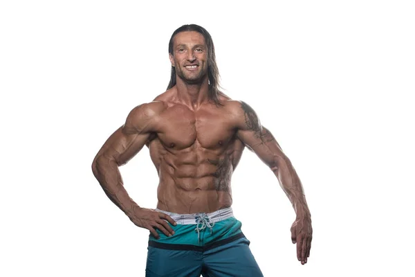 Musclé Bodybuilder Guy posant sur fond blanc — Photo
