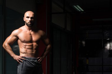 Yakışıklı kaslı adam içinde jimnastik salonu kas esneme