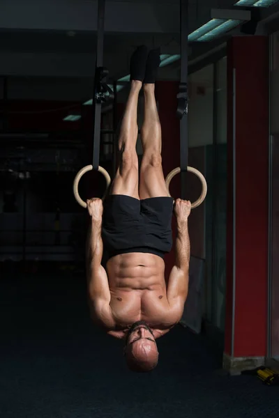 Muscular Athlete Hanging On Gymnastic Rings — Stock Photo, Image