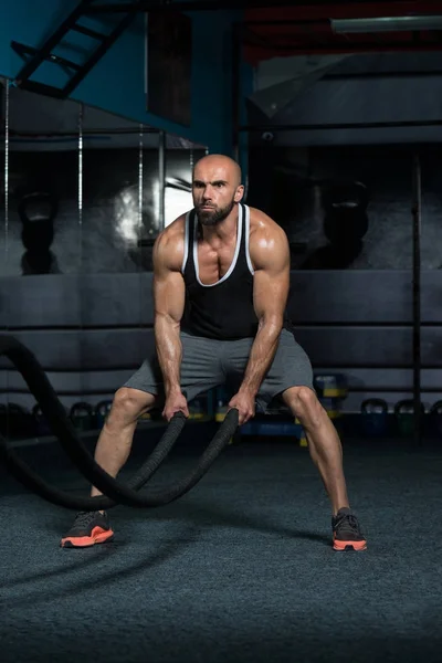 Strijdende touwen jonge man op Gym Workout Oefening — Stockfoto