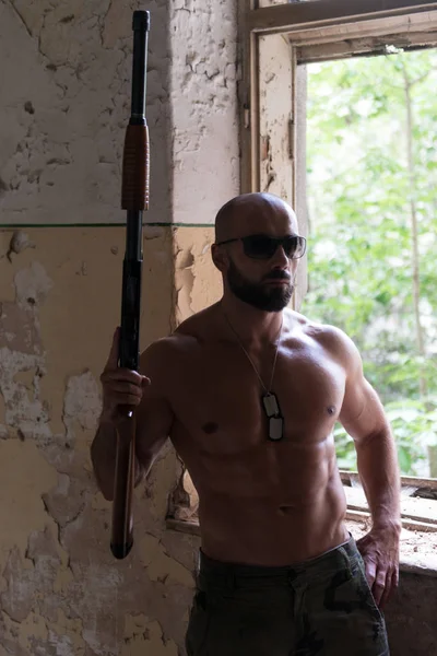 Confident Man Portrait With Machine Gun