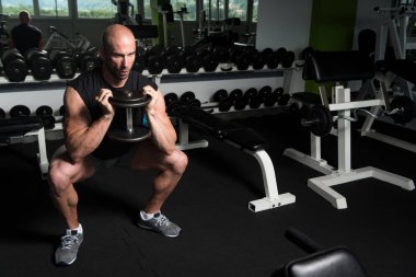Kaslı adam kuadriseps Dumbbells ile egzersiz