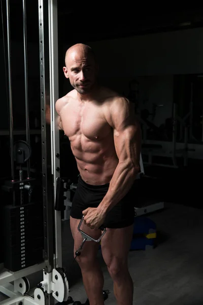 Kablo ile omuz için ağır egzersiz yaparak vücut geliştirmeci — Stok fotoğraf