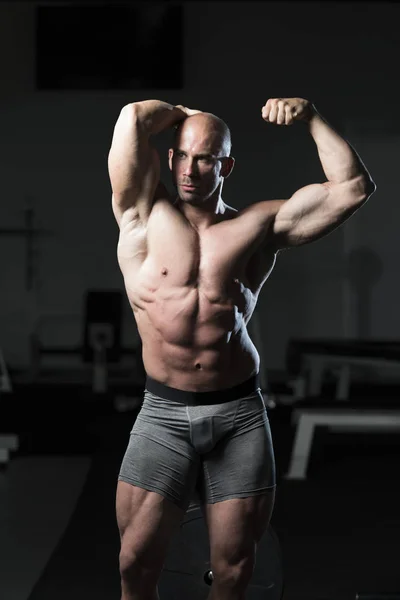 Kroppsbyggare poserar dubbel Biceps efter övningar — Stockfoto