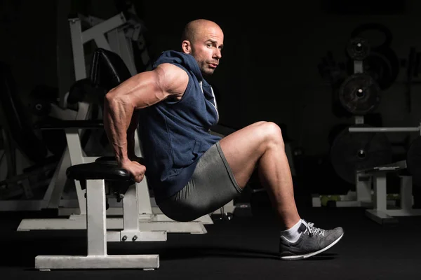 Člověk vykonávající Triceps na lavičce v tělocvičně — Stock fotografie