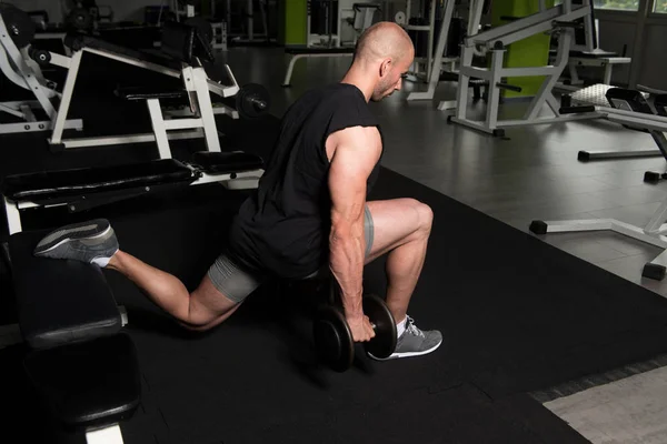Man Athlete Exercising Glutes With Dumbbell