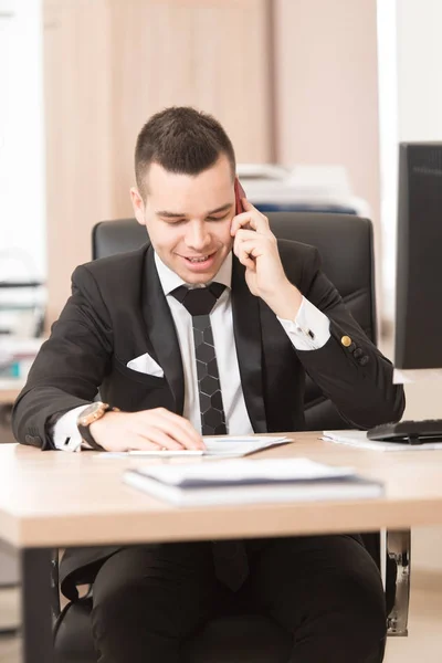 Manier inzakenman praten op telefoon in office — Stockfoto