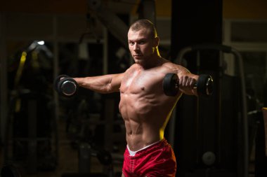 Vücut geliştirmeci omuz Dumbbells ile egzersiz