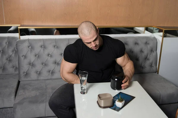 Bodybuilder Posing With Supplements For Copy Space — Stock Photo, Image