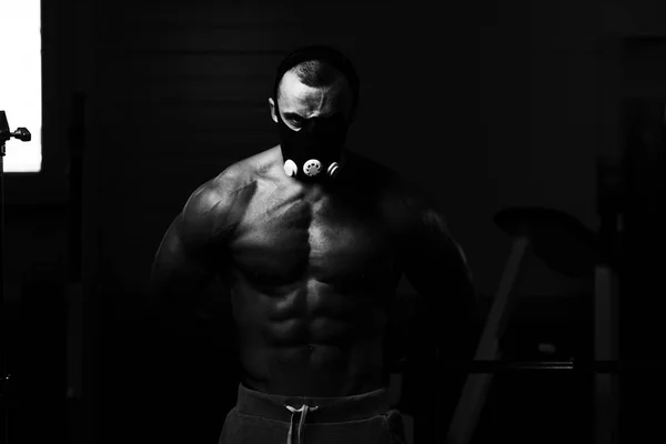 Muscular Man Flexing Muscles In Elevation Mask