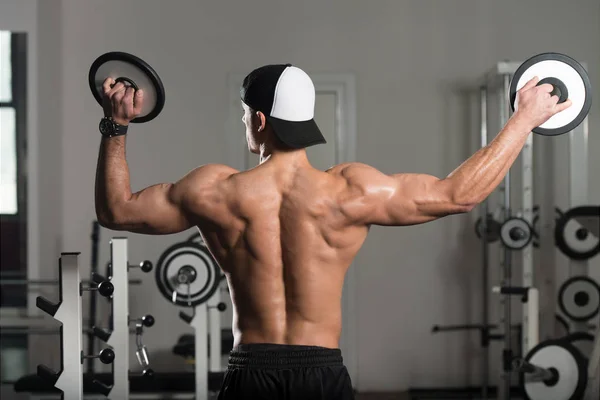 Muscular Man Flexing Muscles With Weights