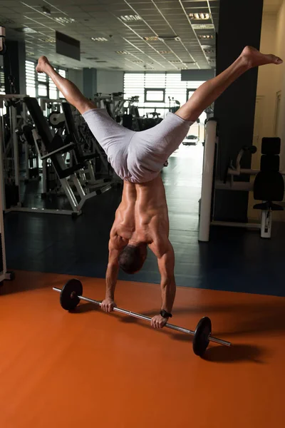 Bodybuilder uitoefening Handstand Push-Ups op Barbell In sportschool — Stockfoto