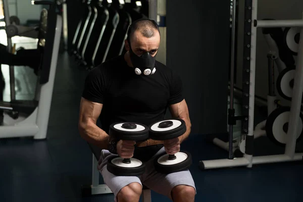 Exercício de bíceps com halteres na máscara de elevação — Fotografia de Stock