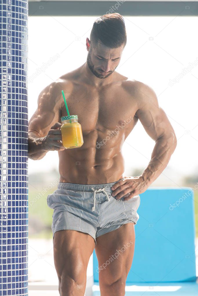 Man Holding a Glass of Orange Juice