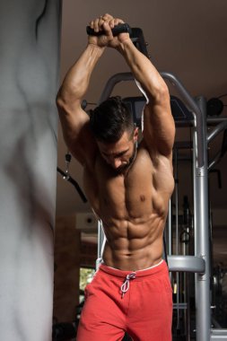 Kablosu ile Triceps için ağır egzersiz yaparak vücut geliştirmeci