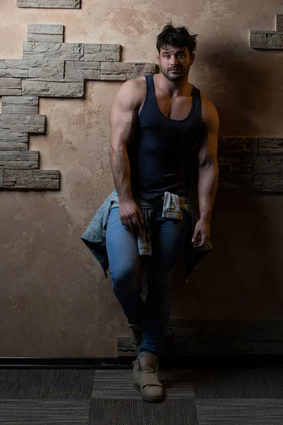 Modelo Flexing Muscles Against a Brick Wall —  Fotos de Stock