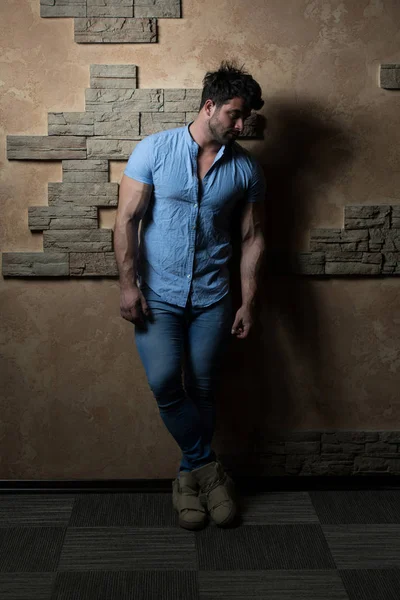 Man in Jeans Shirt Standing on Brick Background — Stock Photo, Image