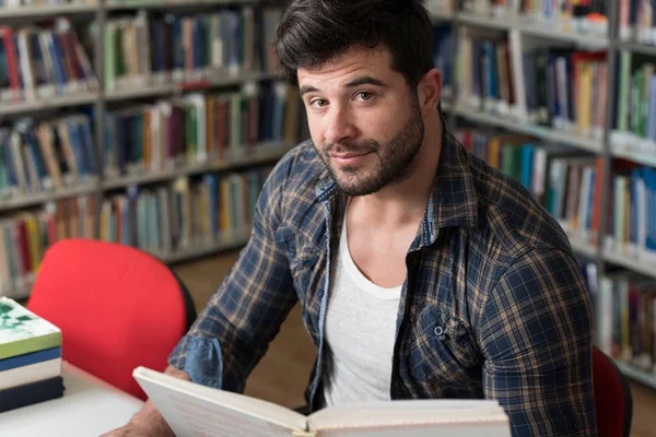 Hermoso estudiante universitario en una biblioteca — Foto de Stock