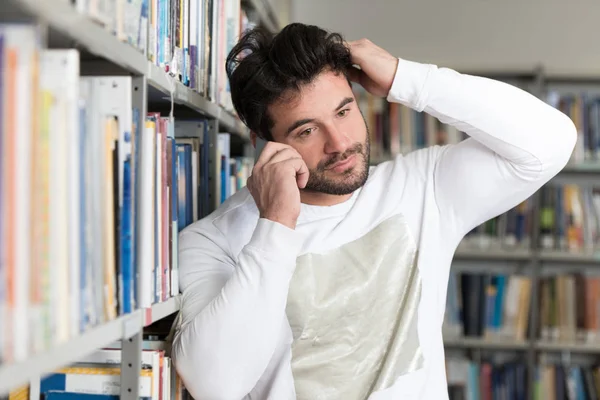 Estudiante hablando por teléfono en la biblioteca — Foto de Stock
