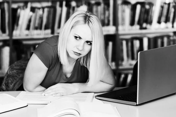 Étudiante confondue lisant de nombreux livres pour l'examen — Photo